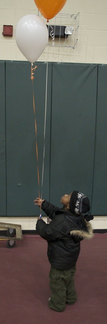 Boy with balloons at the Sigel hub Hope Is Moving In launch. (November 2009)
