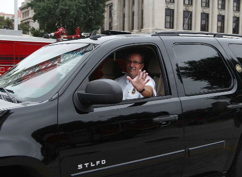 During the 2014 Fire Engine Parade Chief Jenkerson waves to the crowd.