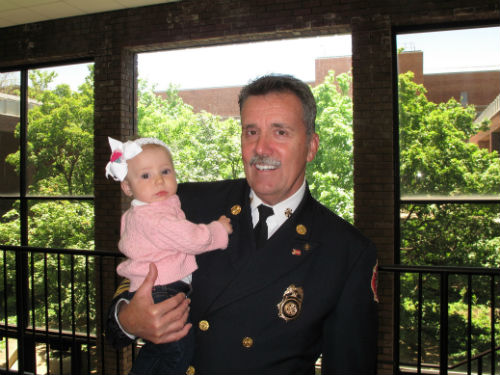 Fire Chief Dennis Jenkerson with his granddaughter, Margot.