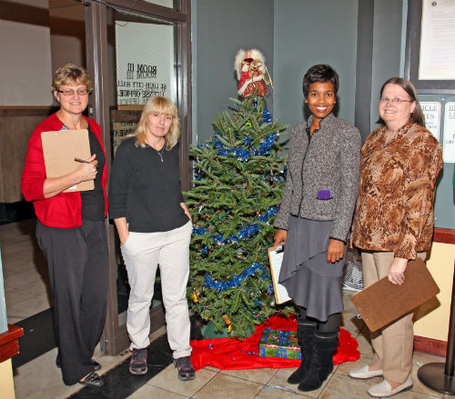 DOR staff and contest judges pose by the Charlie Brown entry in the 2012 Tree Decorating Contest.
