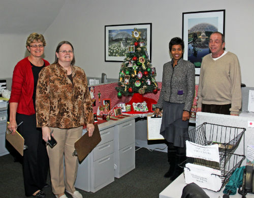 COR staff and contest judges pose by the Family Traditions entry in the 2012 Tree Decorating Contest.