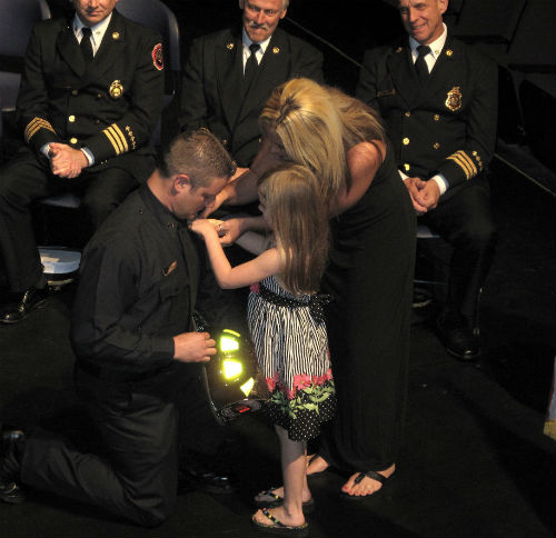 Family pins badge on new firefighter