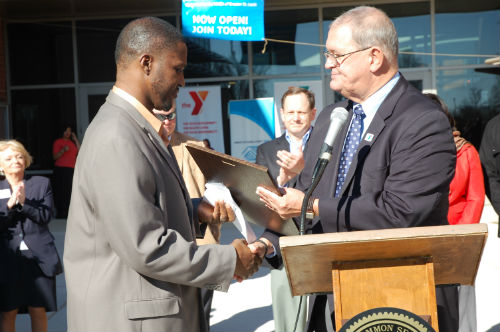 Gary Schlansker presents the Y-USA Charter to Rob West, executive Director of the O'Fallon Park RecPlex.