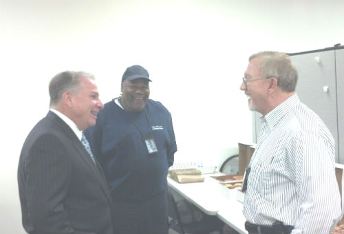 Gregg Daly, Arnold Mitchell, and Rich Voelker enjoy refreshments after the ceremony