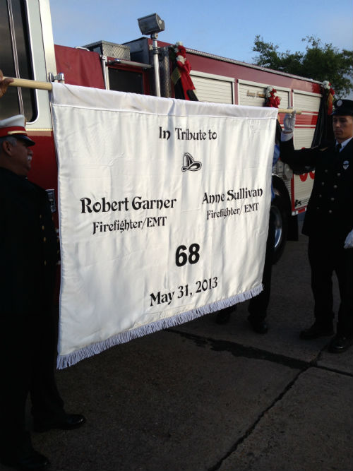 A tribute banner for two of the fallen Houston firefighters.