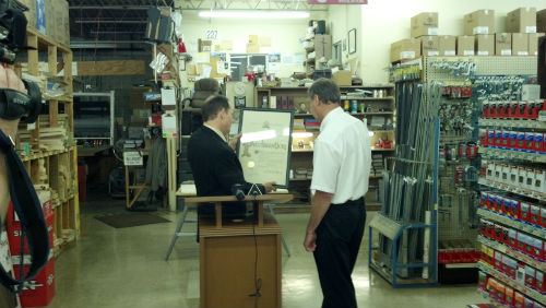 Mayor Slay presents a proclamation to John Edele from Edele and Mertz Hardware on June 6, 2012, the 100th anniversary of the business.