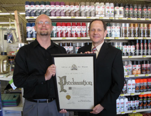 Michael Bradley of Hub Furniture proudly accepts the proclamation from Mayor Francis Slay on behalf of the 114-year-old business.