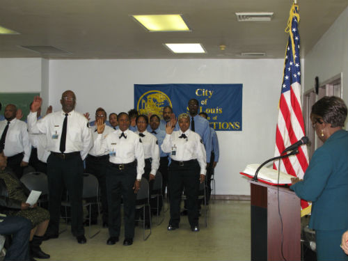 City Register Parrie May administers the oath of office.