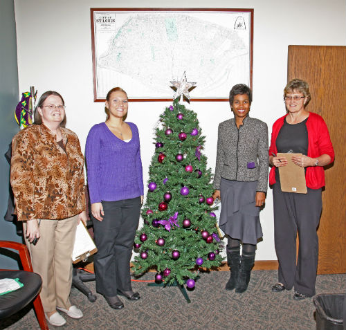 COR staff and contest judges pose by the Purple entry in the 2012 Tree Decorating Contest.