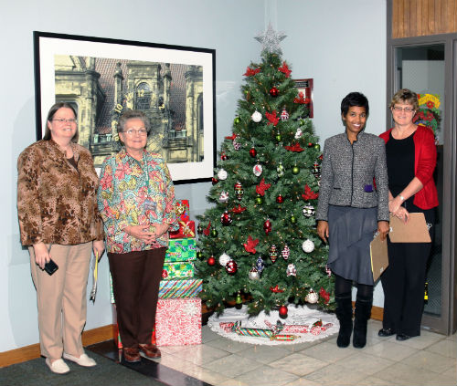 COR staff and contest judges pose by the Red Bird entry in the 2012 Tree Decorating Contest.
