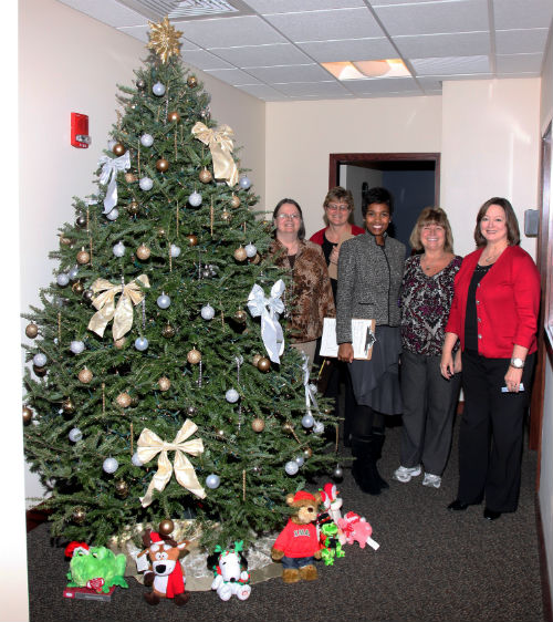 COR employees and contest judges pose by the Silver and Gold entry in the 2012 Tree Decorating Contest.