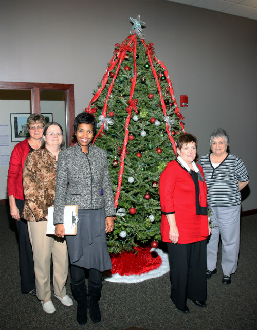COR employees and contest judges pose by The Big Behemoth entry in the 2012 Tree Decorating Contest.