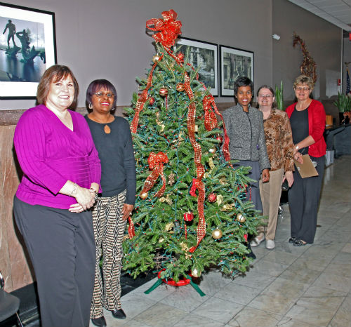 COR employees and contest judges pose by the Victorian entry in the 2012 Tree Decorating Contest.