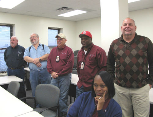 Arnold Mitchell's co-workers wait for the ceremony to begin.
